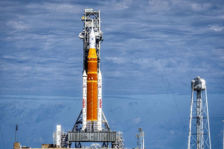The orange Space Launch System rocket on its launch pad