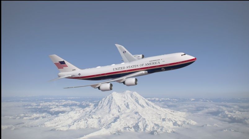 Rendering of the next Air Force One, a 747-8, flying past a snow-covered mountain